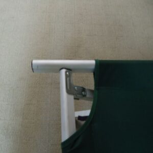 close up of corner of green cot with white supports
