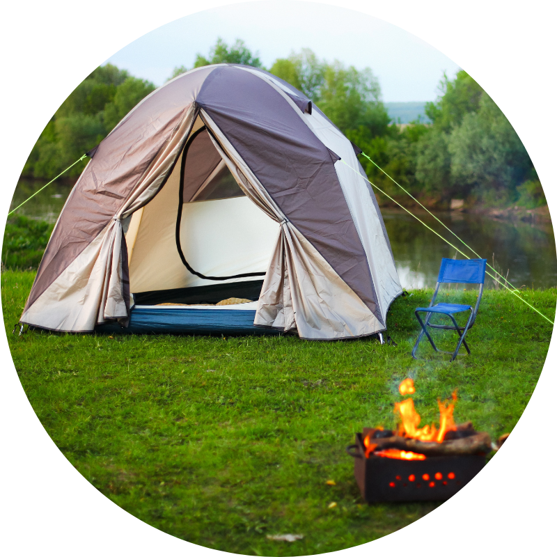 camping tent with fire pit next to river