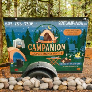 Campanion camping equipment rental trailer on a campsite